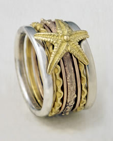 Seven band 'Stacking Ring' in mixed metals with Starfish motif in gold.